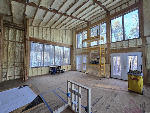 misc room with a towering ceiling and french doors