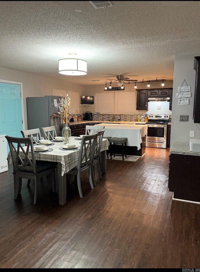 dining room featuring dark hardwood / wood-style floors and a textured ceiling