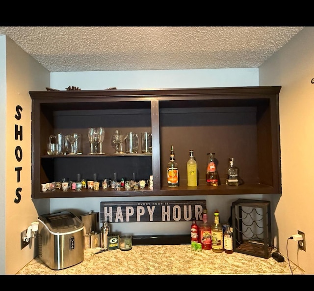 bar featuring a textured ceiling