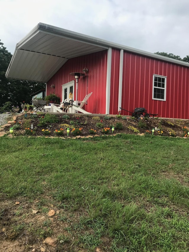 view of outbuilding featuring a yard