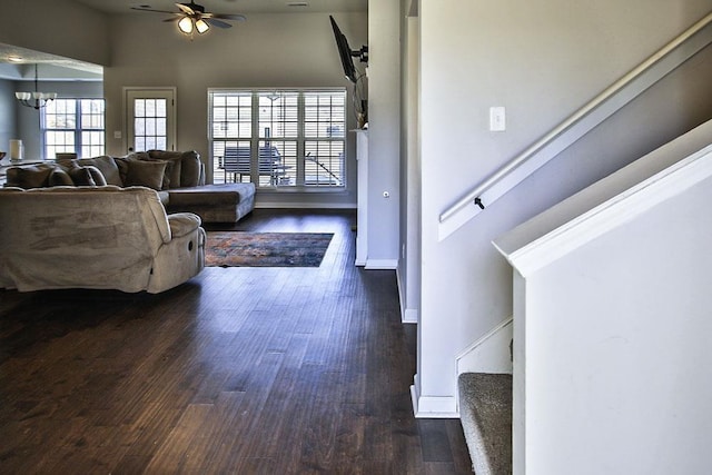 entryway with dark wood-type flooring, plenty of natural light, and ceiling fan with notable chandelier