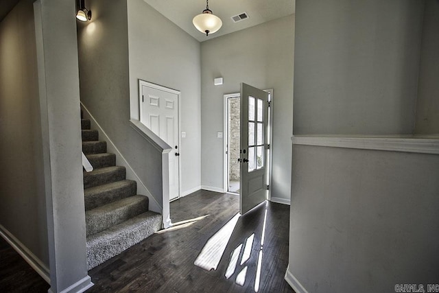 foyer entrance featuring a high ceiling and dark hardwood / wood-style floors