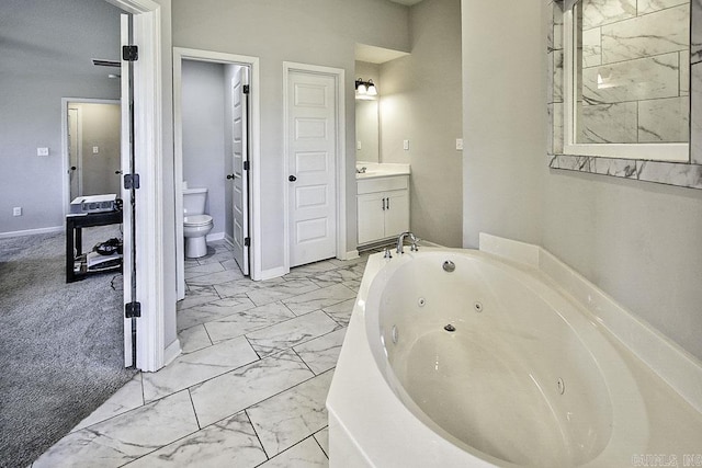 bathroom with toilet, vanity, and a bathing tub