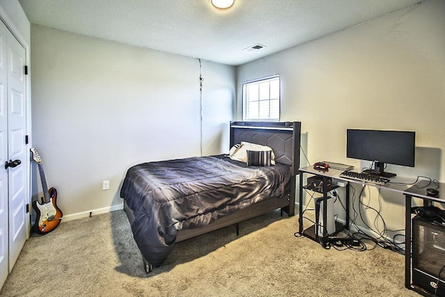 carpeted bedroom with a textured ceiling