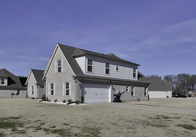 rear view of property featuring a garage