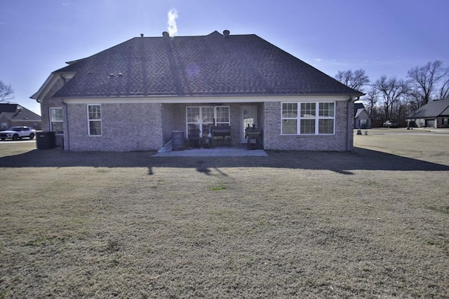 back of house with a patio area and a yard