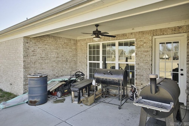 view of patio with ceiling fan and a grill