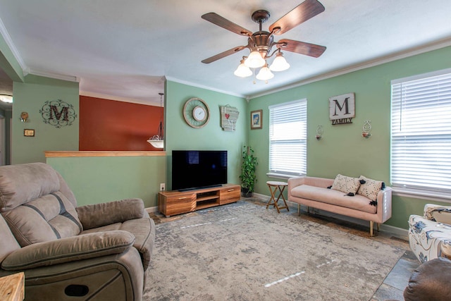 living room with ceiling fan, crown molding, and plenty of natural light