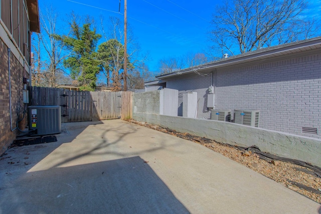 view of yard with cooling unit and a patio