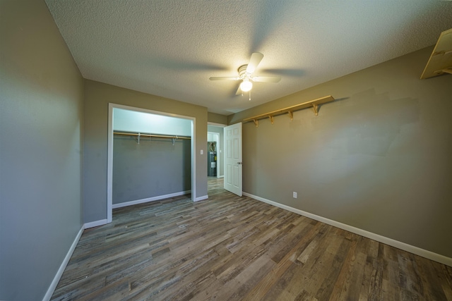 unfurnished bedroom with ceiling fan, wood-type flooring, a closet, and a textured ceiling