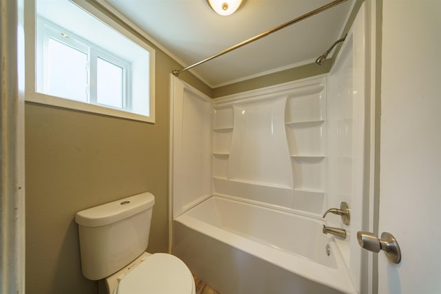 bathroom with toilet, bathing tub / shower combination, and ornamental molding