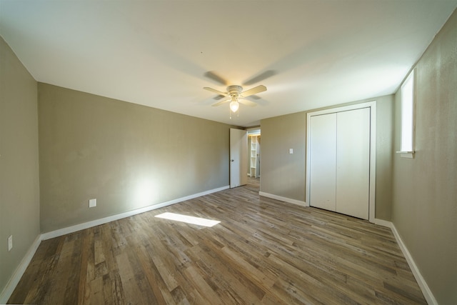 unfurnished bedroom with ceiling fan, light hardwood / wood-style floors, and a closet