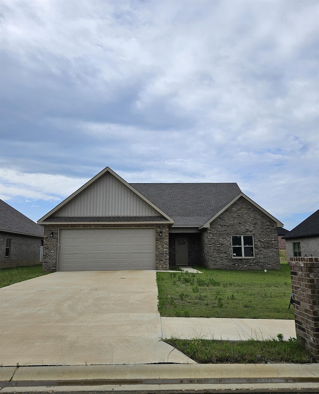 single story home featuring a garage and a front yard