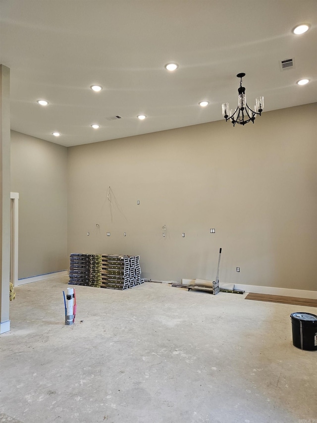 spare room featuring an inviting chandelier