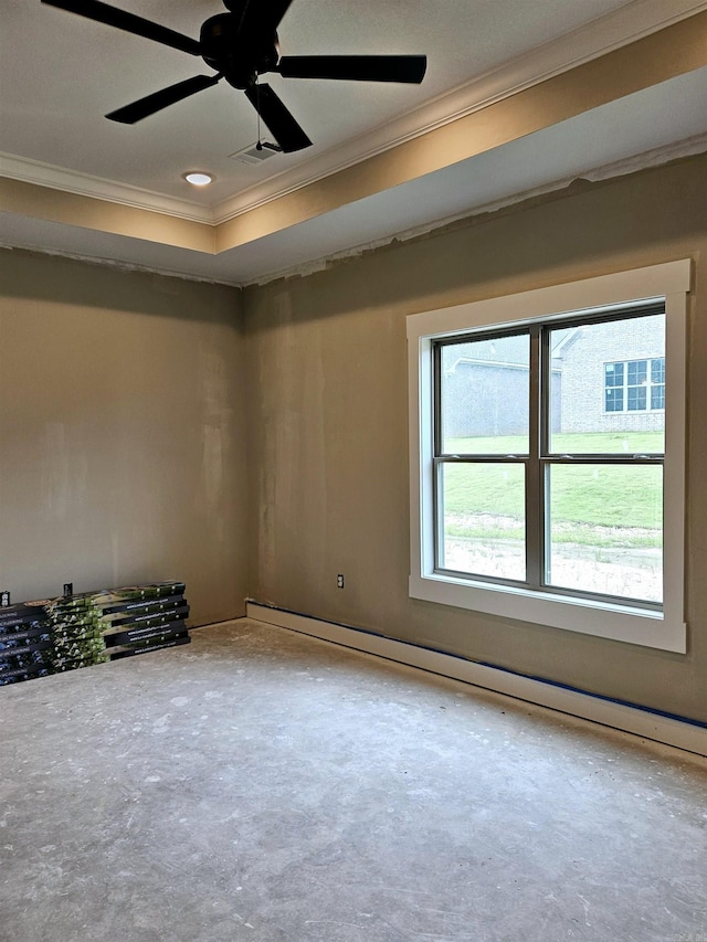 empty room with ceiling fan, ornamental molding, a raised ceiling, and a baseboard radiator