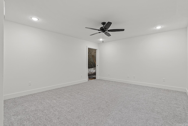 unfurnished room with ceiling fan and light colored carpet