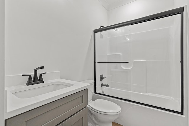 full bathroom with toilet, combined bath / shower with glass door, crown molding, and vanity