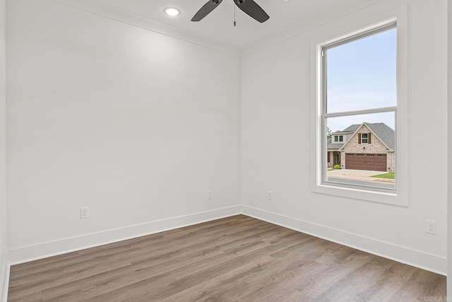 unfurnished room with ceiling fan, light hardwood / wood-style flooring, and ornamental molding