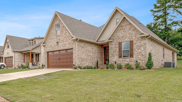 view of front of house with a front lawn, a garage, and central air condition unit