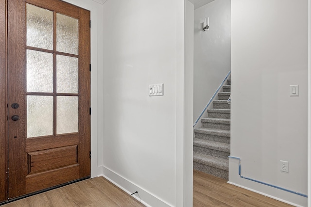 entryway with hardwood / wood-style floors