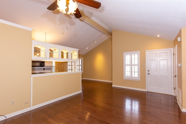 unfurnished living room with dark hardwood / wood-style floors, ceiling fan, and vaulted ceiling with beams