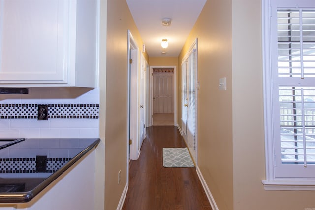 corridor with dark hardwood / wood-style floors