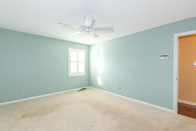 carpeted empty room with ceiling fan