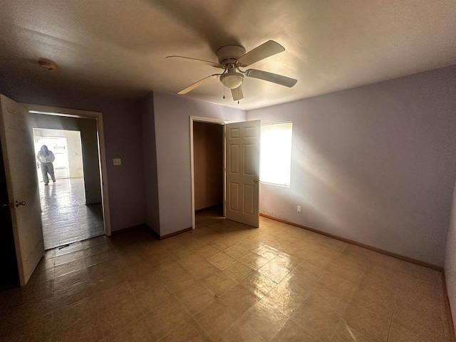 unfurnished bedroom featuring ceiling fan