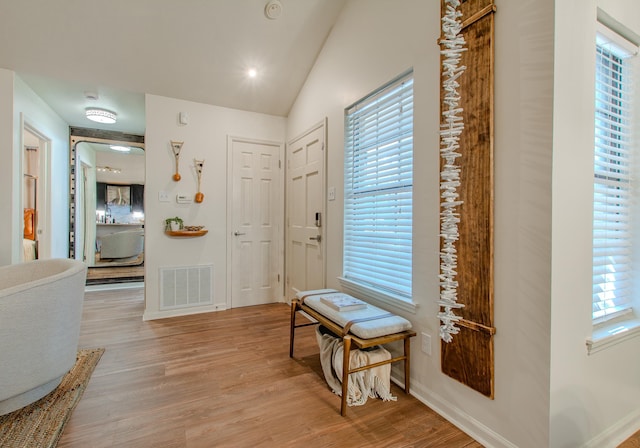 entrance foyer featuring vaulted ceiling and light wood-type flooring