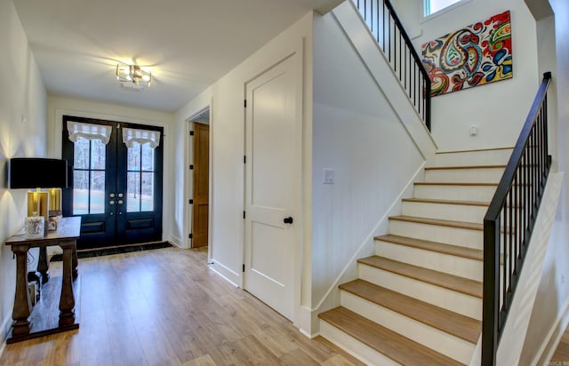 foyer featuring light hardwood / wood-style floors and french doors