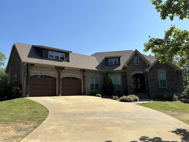 french country inspired facade featuring a front yard and a garage