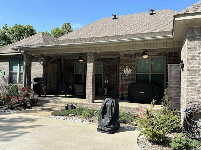 rear view of property with ceiling fan and a patio area
