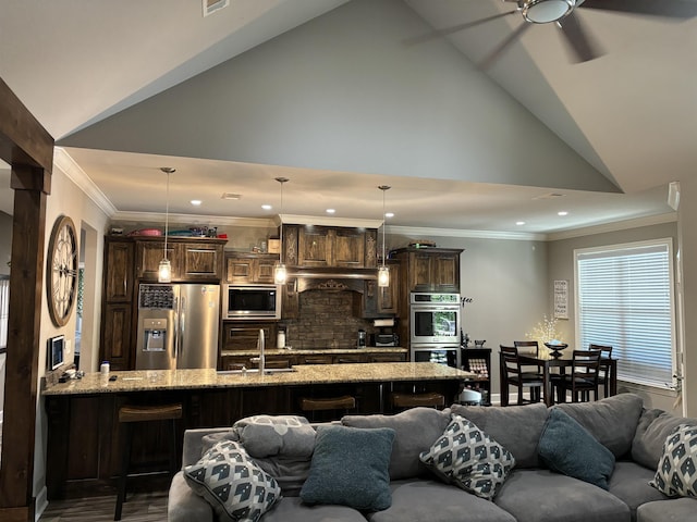living room featuring ceiling fan, sink, ornamental molding, and lofted ceiling