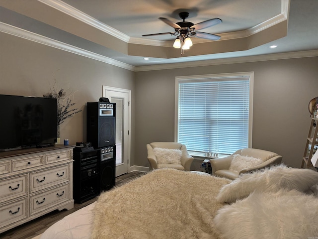 bedroom featuring ceiling fan, crown molding, and a tray ceiling