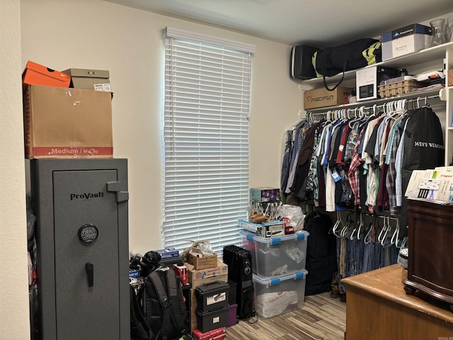 walk in closet with light hardwood / wood-style floors