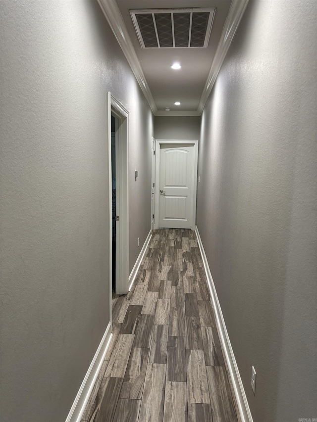 hall with hardwood / wood-style floors and crown molding