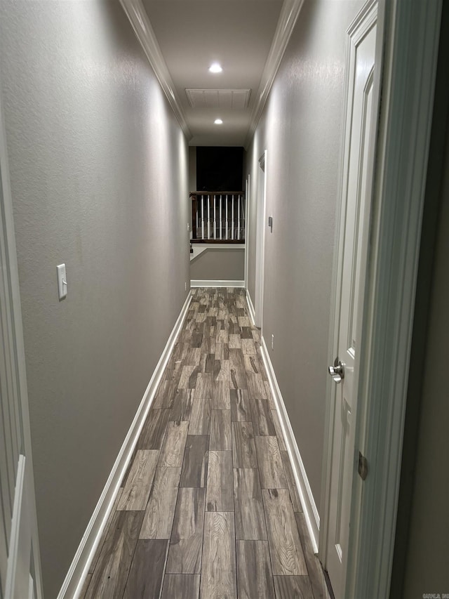 hallway with hardwood / wood-style flooring and ornamental molding
