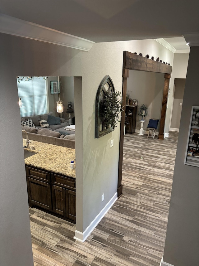 corridor featuring a wall unit AC, crown molding, and light hardwood / wood-style floors