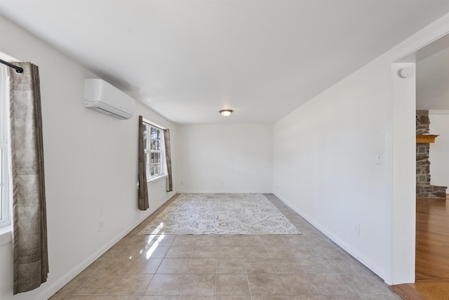 unfurnished room with light tile patterned flooring, a wall mounted AC, and a fireplace