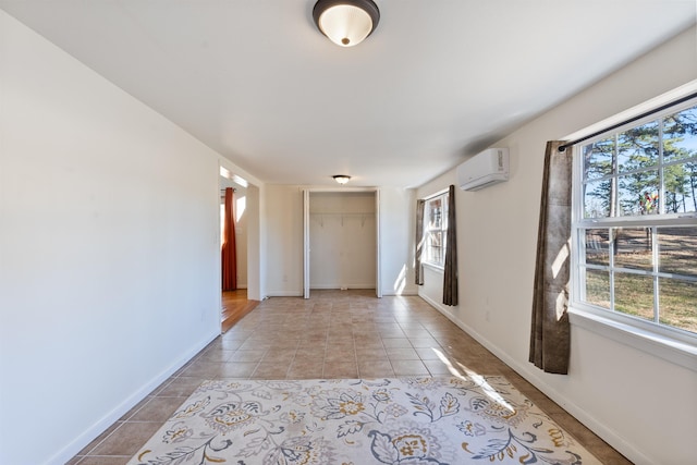 hall featuring plenty of natural light, a wall unit AC, and light tile patterned flooring