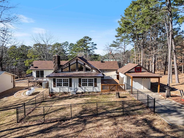 view of front of house featuring a garage, central AC unit, and an outdoor structure