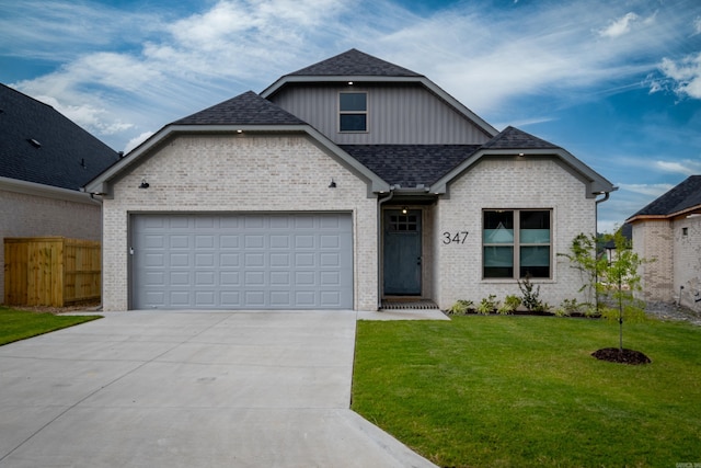 view of front of property with a garage and a front lawn