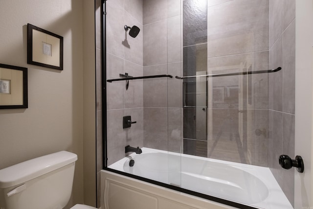 bathroom featuring toilet and enclosed tub / shower combo