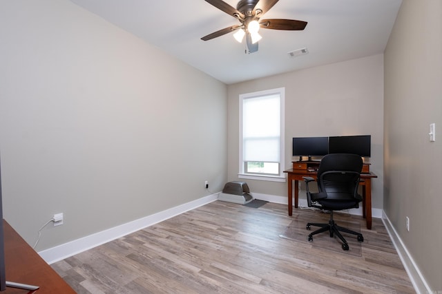 office with ceiling fan and light hardwood / wood-style flooring