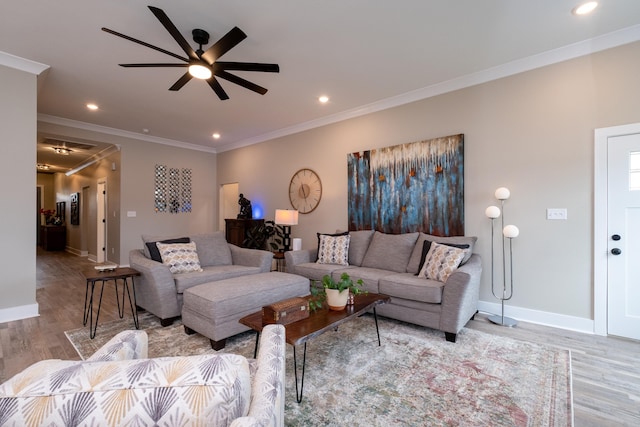 living room featuring light wood-type flooring, ceiling fan, and ornamental molding