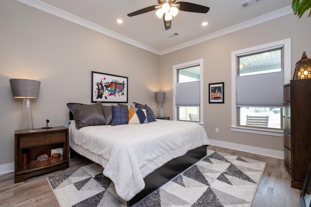 bedroom with ceiling fan, light hardwood / wood-style flooring, and ornamental molding