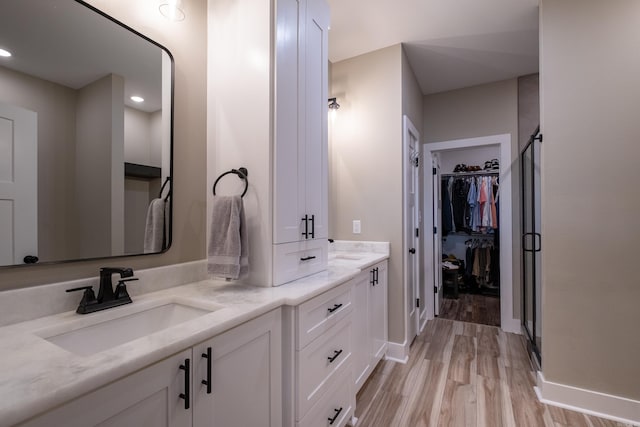 bathroom with hardwood / wood-style floors and vanity