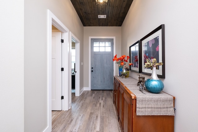 doorway featuring light hardwood / wood-style floors and wood ceiling