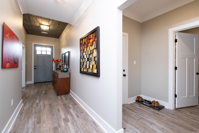 hall with wooden ceiling, crown molding, and light hardwood / wood-style floors