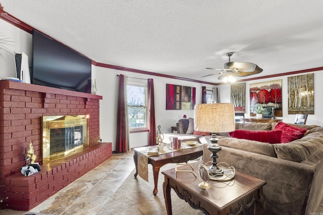 living room featuring ceiling fan, a brick fireplace, a textured ceiling, and ornamental molding